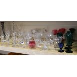 A collection of 19th century glassware including firing glasses, coloured wines and a ladle