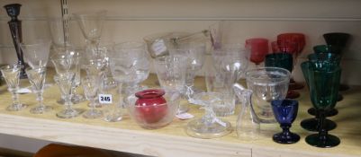 A collection of 19th century glassware including firing glasses, coloured wines and a ladle