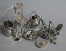 A collection of miniature silver and other novelties, including a chair with decorative foliate