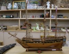 A wooden model of a three masted ship length 81cm