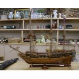 A wooden model of a three masted ship length 81cm