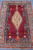 A Caucasian red and blue ground rug W.174cm x 120cm