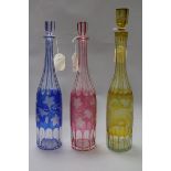 Three Victorian colour overlaid vineous etched glass decanters