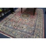 A Persian red ground carpet 371cm x 246cm