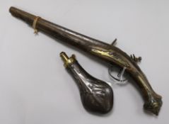 A late 18th century Turkish flintlock pistol and a copper powder flask 48cm. & 20cm.