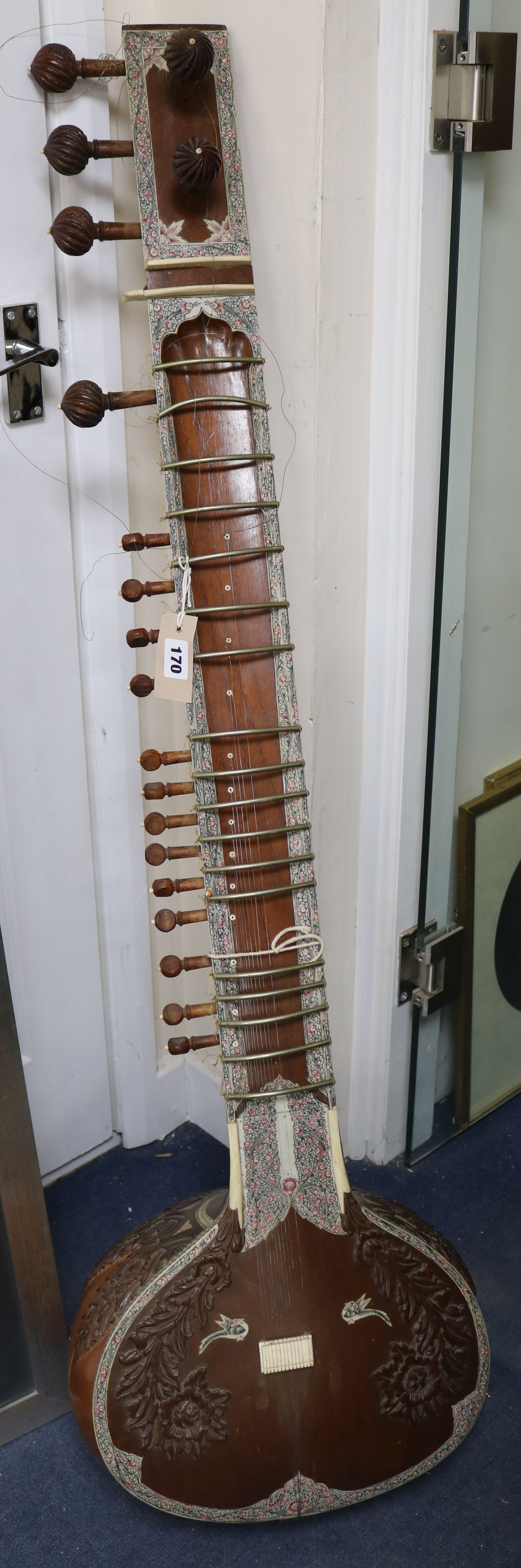 An Indian carved hardwood and decorated sitar 126cm