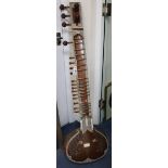 An Indian carved hardwood and decorated sitar 126cm