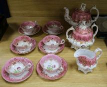 A Victorian nine piece porcelain teaset, painted with tulips