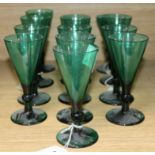 A collection of thirteen assorted 19th century green conical wine glasses largest 15cm