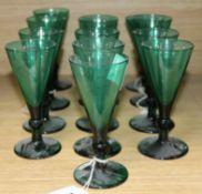 A collection of thirteen assorted 19th century green conical wine glasses largest 15cm