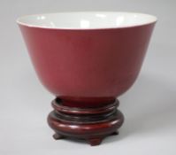 A Chinese red glazed tea bowl on stand 10.5cm