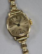 A lady's 9ct gold Rotary manual wind wrist watch, on a 9ct gold bracelet.