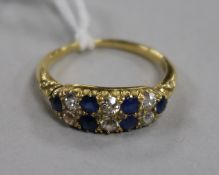 An early 20th century 18ct gold, sapphire and diamond twin row half hoop ring, size N.