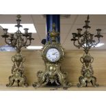 An early 20th century French cast brass three piece clock garniture H.69cm.