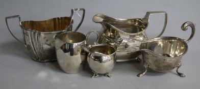 A George III silver oval cream jug, three other silver cream jugs, various and a silver sugar