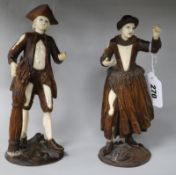 A pair of late 19th century French bone and walnut figures of peasants 22cm