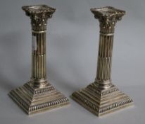 A pair of late Victorian silver corinthian column dwarf candlesticks by Goldsmiths & Silversmiths Co