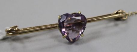 A yellow metal and heart shaped amethyst set bar brooch, 49mm.