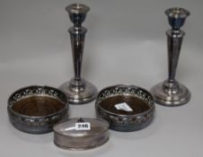 A pair of silver plated wine coasters, a pair of candlesticks and a box
