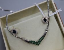 A 9ct white gold and emerald-set pendant on chain and a pair of 9ct gold diamond and sapphire stud