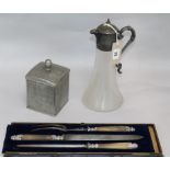 A three piece carving set, claret jug and caddy H 27.5cms