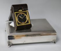A Doka eight-day military travelling clock and a plated cigarette box, the clock having circular
