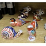 Eight assorted Royal Crown Derby paperweights, modelled as birds and a snail