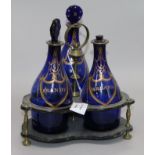 A set of three Regency Bristol blue glass decanters in a papier mache stand