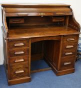 An early 20th century oak roll top desk W.122cm