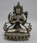 A Tibetan silvered bronze seated figure of a deity 20cm