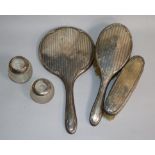 A silver dressing table part set and two match tidies.