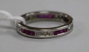 A white metal, ruby and diamond set full eternity ring, size L.