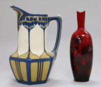 A Mettlach Art Nouveau jug, with floral decoration, 19cm and a Royal Doulton flambe vase, 18cm