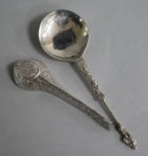 An Indian white metal pouring vessel and a continental apostle spoon.