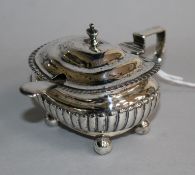A George III demi fluted silver mustard pot, London, 1815 and a plated condiment spoon.