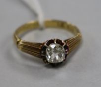 A 20th century 18ct gold and claw set solitaire diamond ring with reeded shoulders, size K.