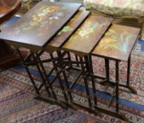 A nest of lacquered quartetto tables with painted floral decoration 56cm