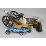 A model cannon, a decoy duck, a miniature 1938 cricket bat and three other items