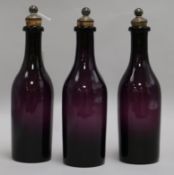 A set of three 19th century amethyst glass decanters, with plated stoppers, height 26cm