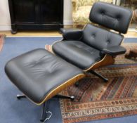 A reproduction Eames chair and stool