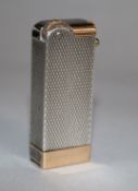 A French 18ct gold and engine turned silver cased lighter, 47mm.