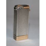 A French 18ct gold and engine turned silver cased lighter, 47mm.