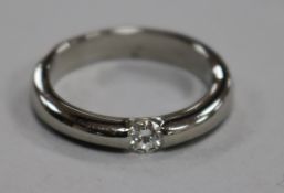 A modern platinum and solitaire diamond ring, size Q.