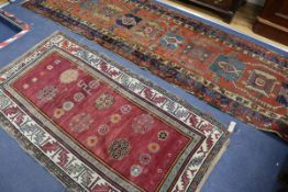 A Caucasian red ground runner, 345cm x 88cm, and a rug 180cm x 94cm