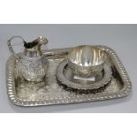 An Indian white metal jug and sugar bowl, a dressing table tray and a small dish