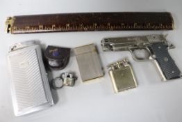 A collection of assorted novelty lighters, a Dupont lighter and a Dunhill lighter
