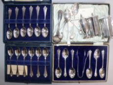 Three cased sets of silver spoons, three silver condiments and four silver small spoons.