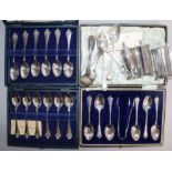 Three cased sets of silver spoons, three silver condiments and four silver small spoons.