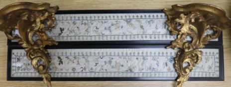 A pair of Chinese embroidered silk sleeve panels, 51.5 x 7cm., and a pair of giltwood wall brackets,