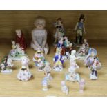 A group of assorted mainly continental porcelain figurines, including a bisque piano baby, 15cm